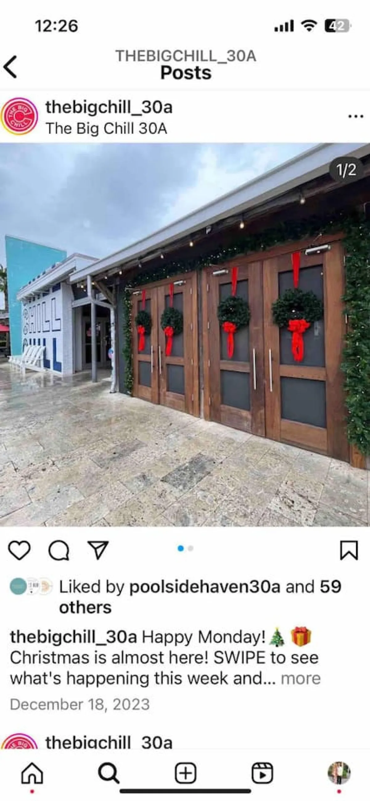 A welcoming entrance with festive holiday decor: double wooden doors adorned with Christmas wreaths and green garland, and a bold 'CHILL' mural on the adjacent wall. The scene suggests a community destination that celebrates seasonal events and offers a lively, inviting atmosphere year-round.